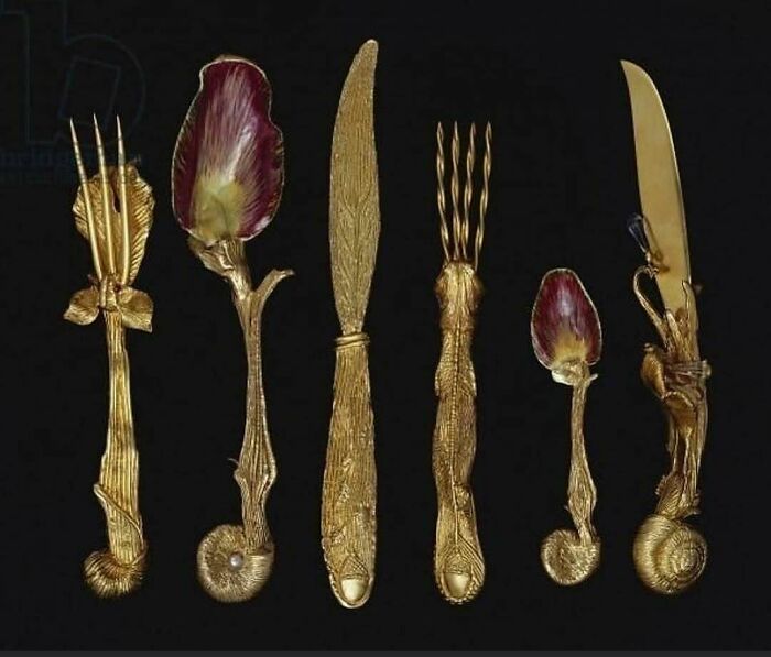 Unique historical cutlery set with ornate, floral designs on a black background, highlighting history cool kids theme.