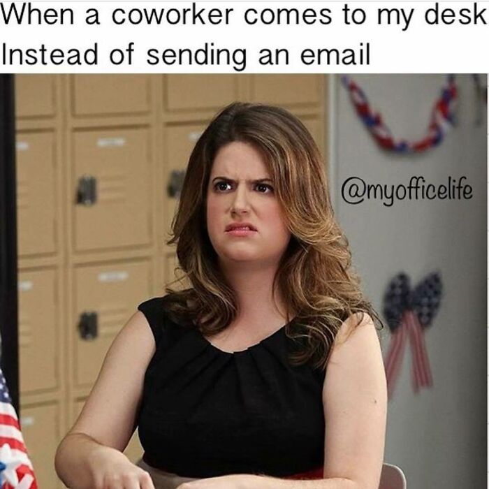 Woman at desk with an annoyed expression, capturing the humor of office interactions for funny meme content.