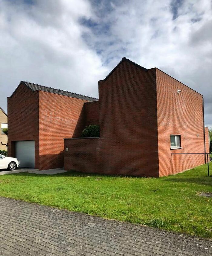 Unique architecture with red brick walls, showcasing a hilariously bad house design spotted in Belgium.