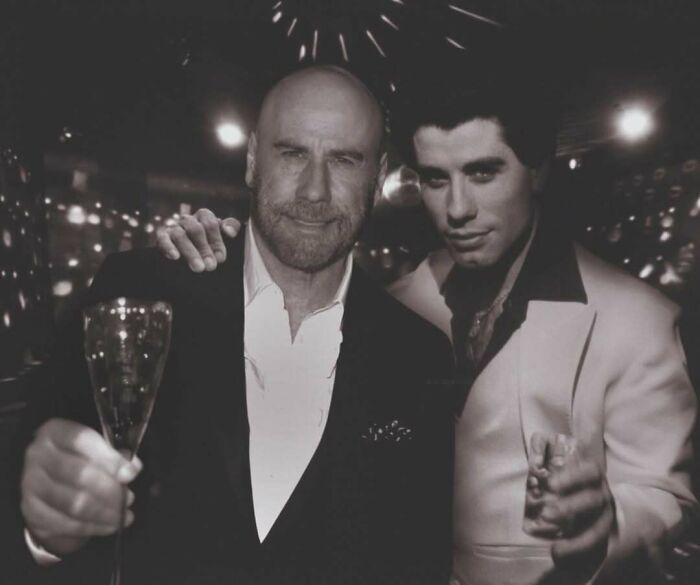 Older and younger celebrity photoshopped together, holding drinks, showcasing time's impact.