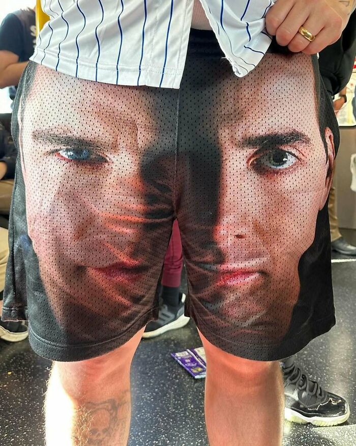 New York local wears unique shorts featuring large face print, showcasing bold fashion experimentation.