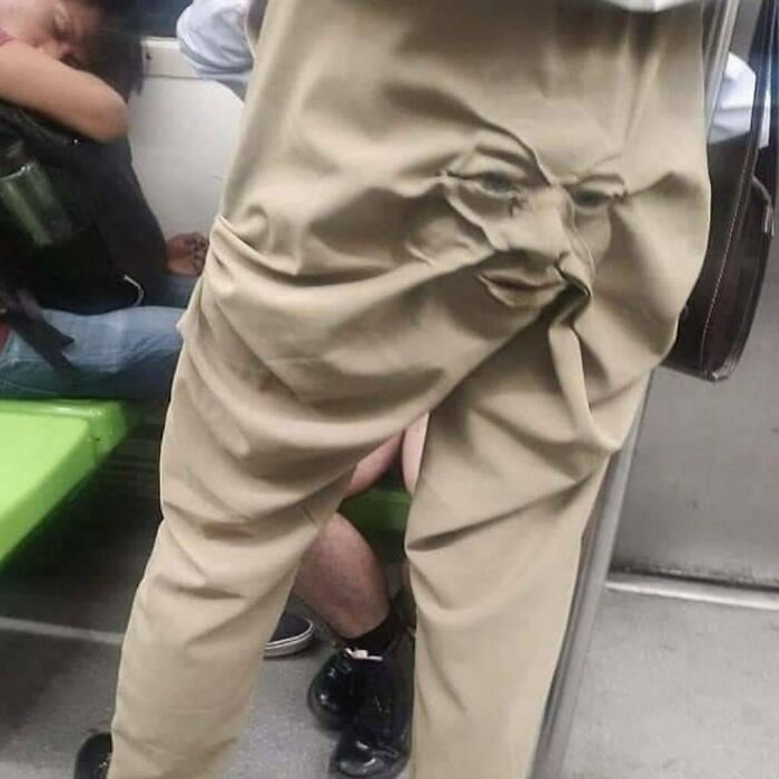 Brown pants wrinkled to resemble a human face, creating a funny and confusing illusion.