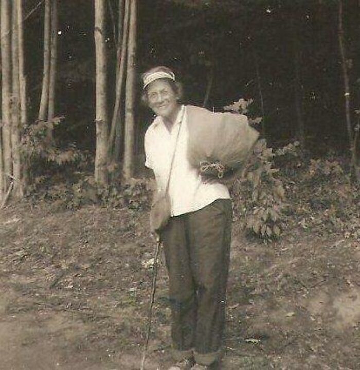 A person in vintage attire standing in a forest clearing, embodying the "History Cool Kids" theme from the past.