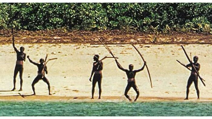 A group of indigenous people on a beach holding bows and arrows, representing "History Cool Kids".