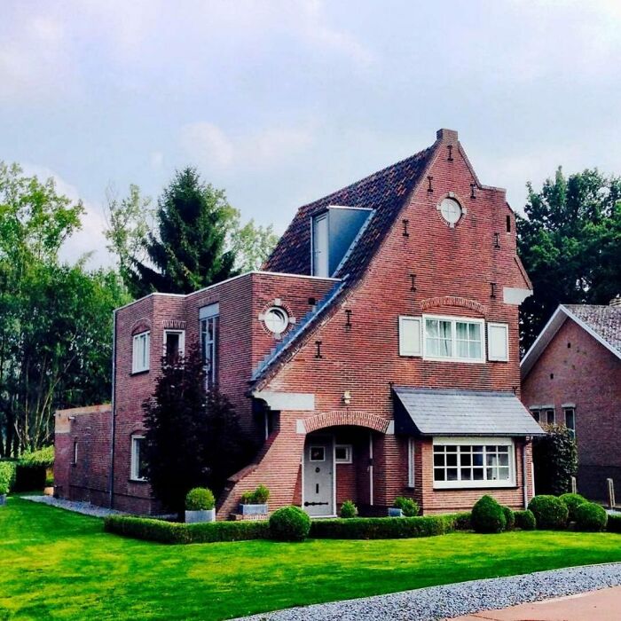 Unusual architecture on a house with mismatched roof angles, showcasing hilariously bad design elements.