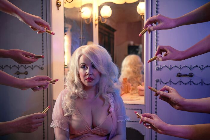 Woman surrounded by hands holding lipsticks, reflecting on beauty standards. Tokyo International Foto Awards entry.