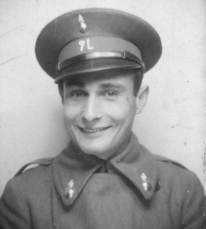 Young soldier smiling in vintage military uniform, showcasing "History Cool Kids" charm.