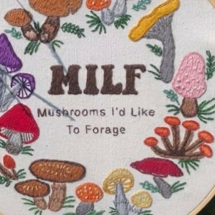 Embroidery of mushrooms with text "M**F: Mushrooms I'd Like To Forage" surrounded by colorful fungi.