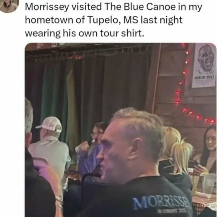 Man wearing a tour shirt at The Blue Canoe in Tupelo, MS, capturing the essence of United States memes.