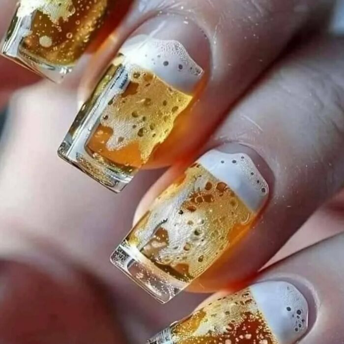 Creative nail art resembling glasses of beer, showing a unique and funny design without context.
