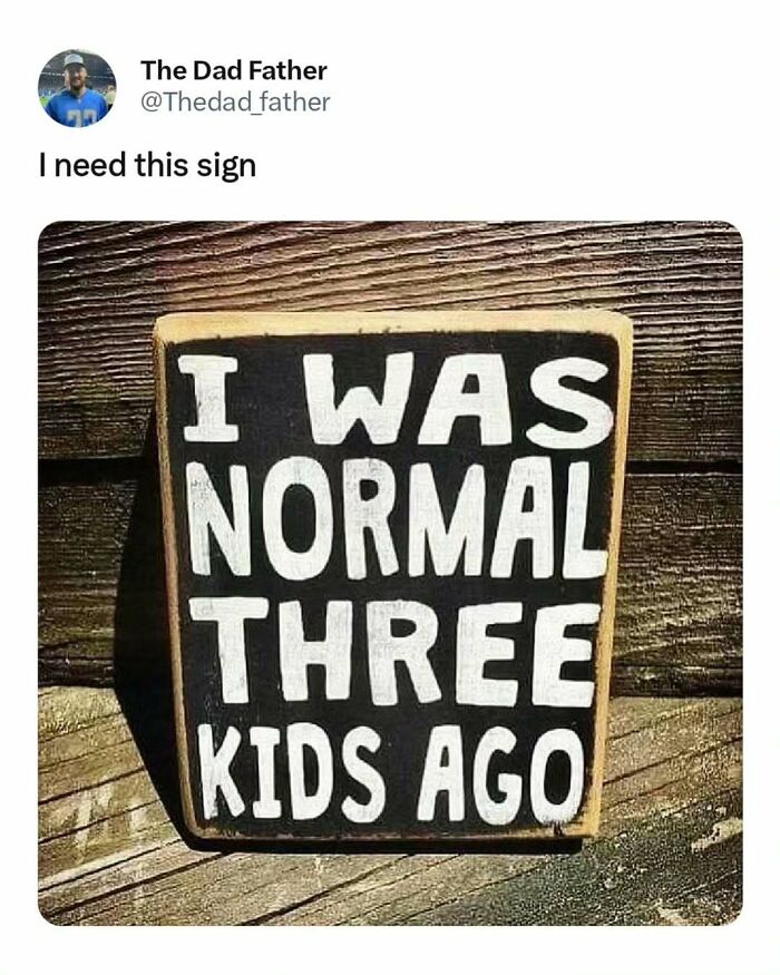 Sign with humorous message about the daily joys and struggles of being a dad: "I was normal three kids ago."