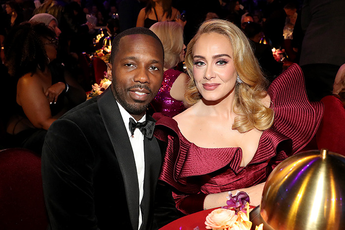 Adele with fiancé Rich Paul, both elegantly dressed, seated at a formal event. Adele with fiancé Rich Paul, both elegantly dressed, seated at a formal event.