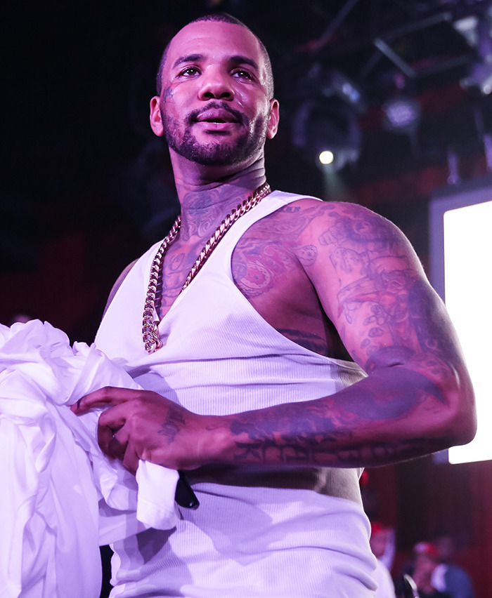 The Game wearing a white tank top and gold chain.