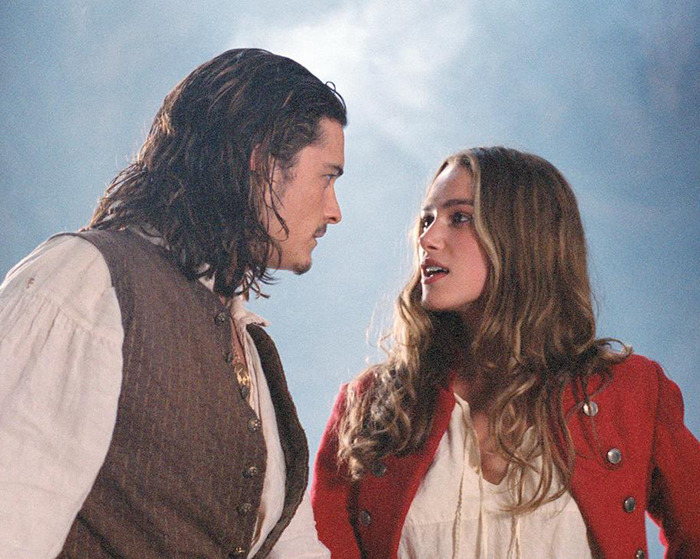 Keira Knightley and Orlando Bloom in a scene from Pirates of the Caribbean, engaging in intense conversation. Keira Knightley and Orlando Bloom in a scene from Pirates of the Caribbean, engaging in intense conversation.