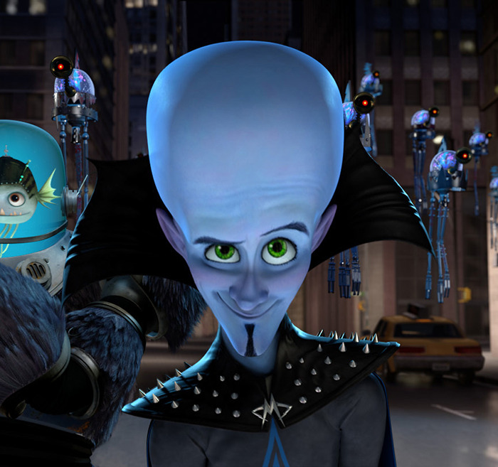 Character resembling 'Megamind' with a large blue head and green eyes, wearing a spiked black outfit in a cityscape. Character resembling 'Megamind' with a large blue head and green eyes, wearing a spiked black outfit in a cityscape.