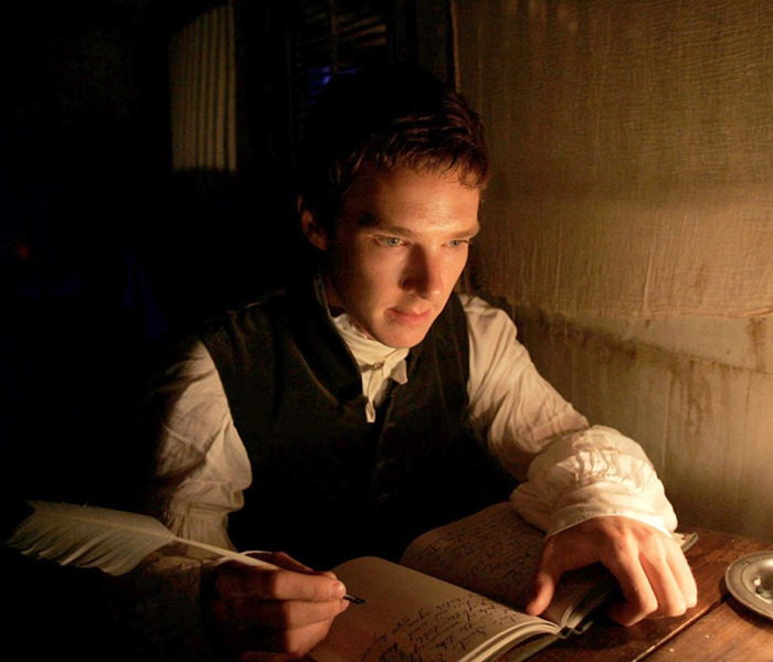 Benedict Cumberbatch writing with a quill by candlelight, deep in thought, in a dimly lit room on a scene from 'To the Ends of the Earth. Benedict Cumberbatch writing with a quill by candlelight, deep in thought, in a dimly lit room on a scene from 'To the Ends of the Earth.