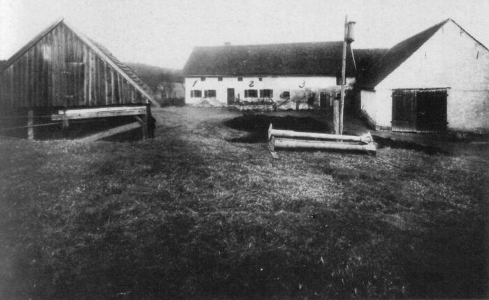 Black and white photo of a farmyard, connected to weird unsolved mysteries.
