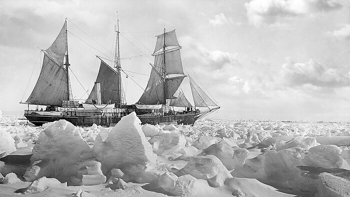 Historic ship navigating icy Antarctic waters, related to the Imperial Trans-Antarctic Expedition.