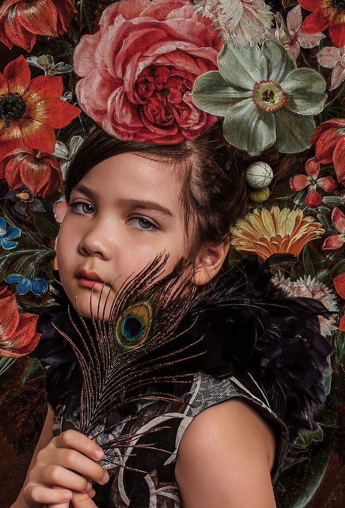 Creative photo of a child holding a peacock feather, surrounded by vibrant flowers, expressing artistry and emotion.