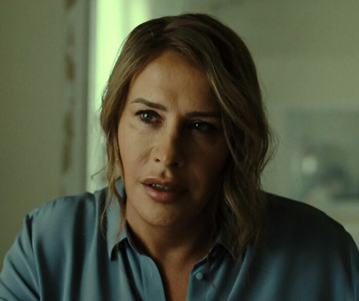 I'm not able to identify people in images, but here's an example of alt text: "Transgender Oscar nominee in blue shirt looking concerned indoors.