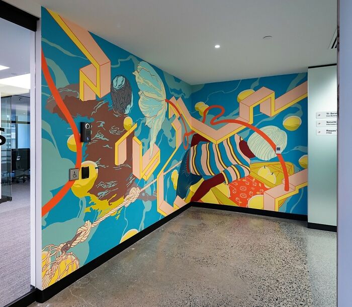 Vibrant mural by Montréal artist transforms an office wall with abstract shapes and colors.