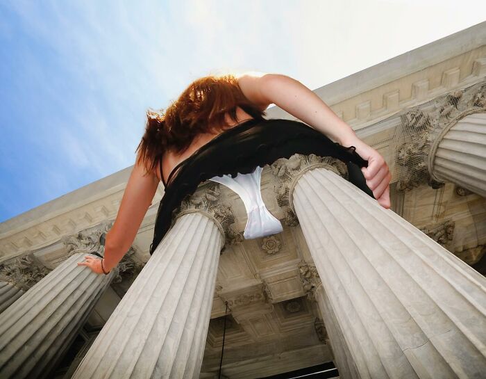 Turkish artist's unexpected collage of a woman merging with building columns, creating an optical illusion.