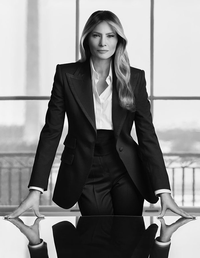 Elegant woman in a black suit in a professional setting, related to freelance magician.