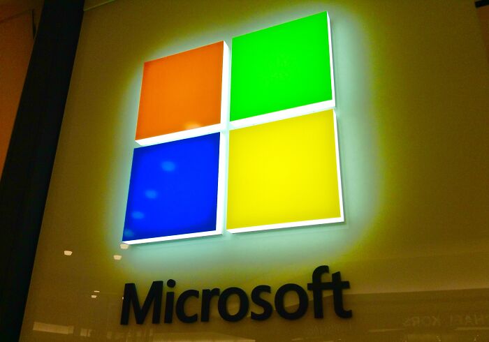Microsoft logo in a store setting, with four colorful squares, highlighting overlooked historical events in tech.