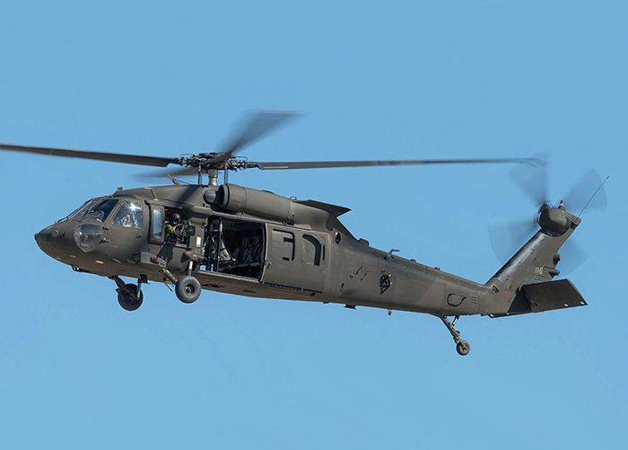 Military helicopter in flight, highlighting concerning practices at civilian airports. Military helicopter in flight, highlighting concerning practices at civilian airports.