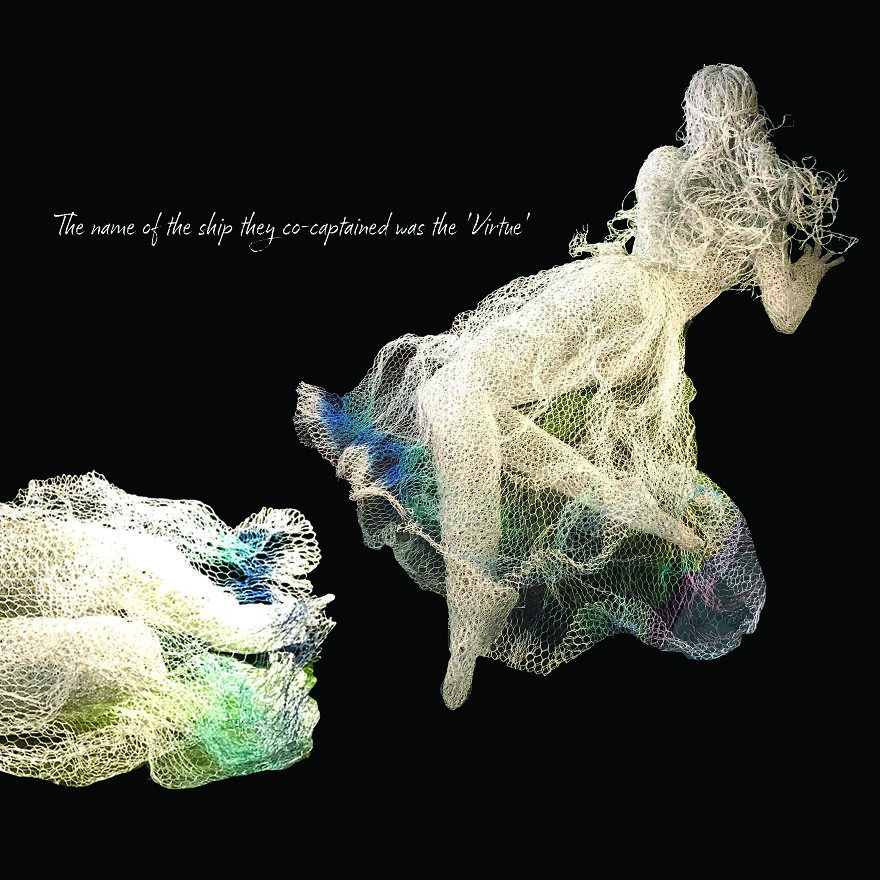 Chicken wire sculpture of a reclining figure against a dark background.