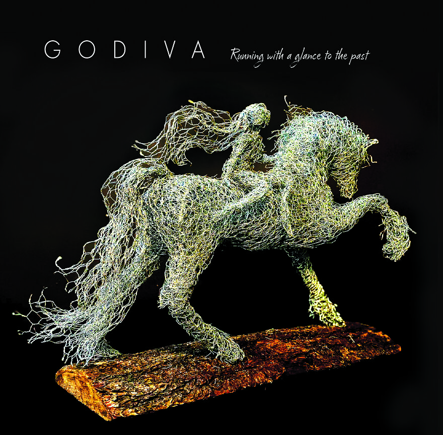 Chicken wire sculpture of a horse and rider titled "Godiva," captured against a black background.