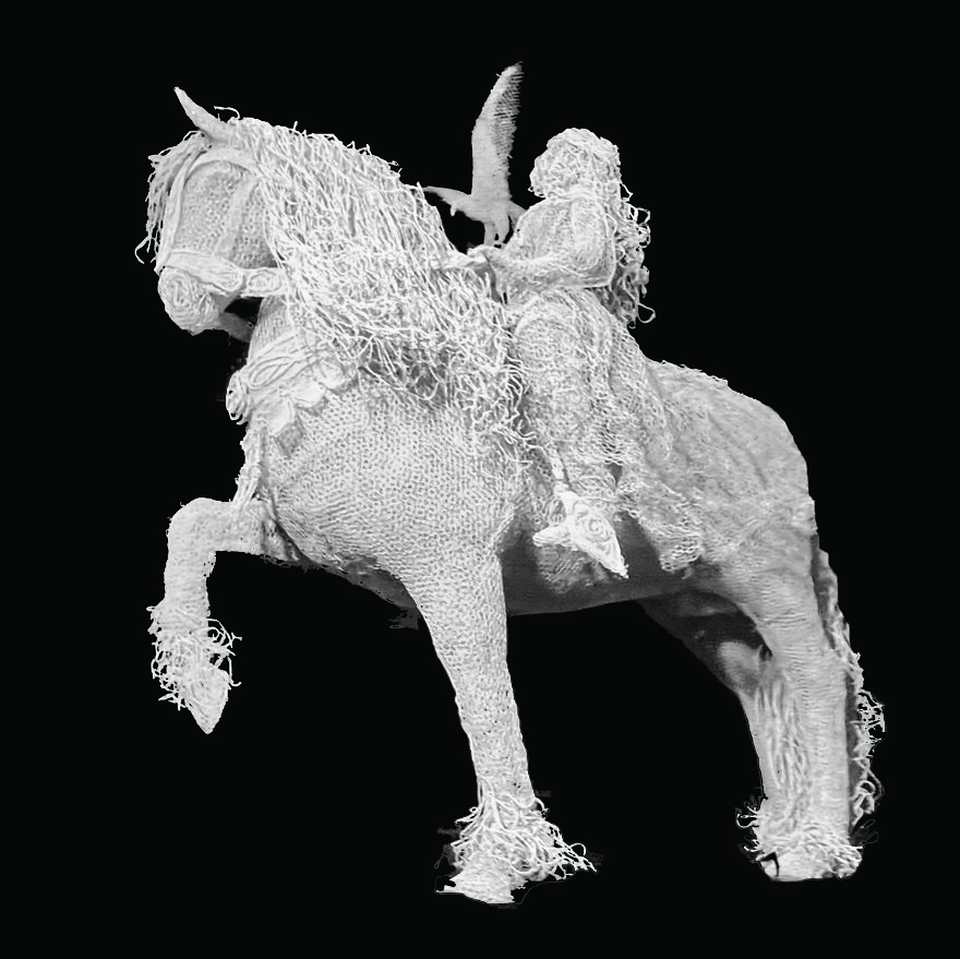 Sculpture of a horse and rider made from chicken wire, showcasing intricate artistry and detail.