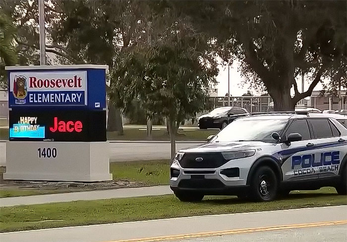 Police car parked outside Roosevelt Elementary, related to school principal arrest incident. Police car parked outside Roosevelt Elementary, related to school principal arrest incident.