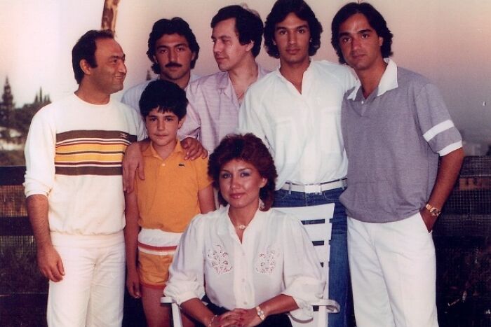 Group photo showcasing people in 80s fashion trends with vibrant and casual clothing outdoors.