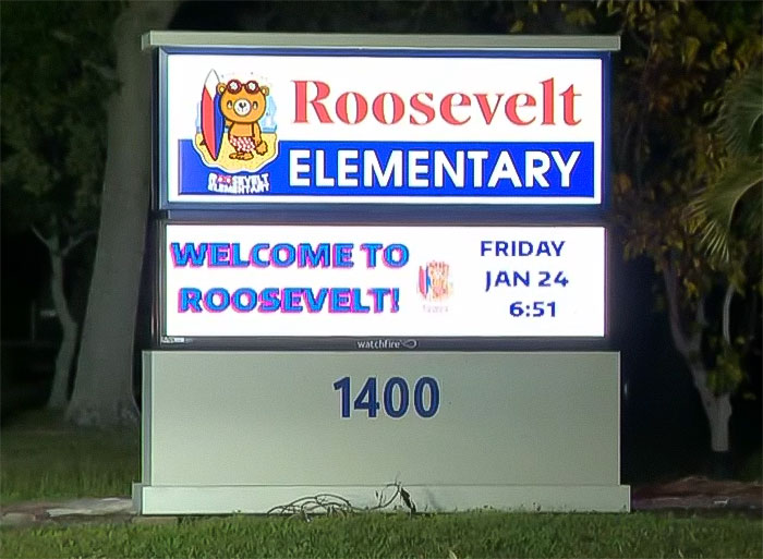 Sign for Roosevelt Elementary, illuminated at night, displaying "Welcome to Roosevelt! Sign for Roosevelt Elementary, illuminated at night, displaying "Welcome to Roosevelt!