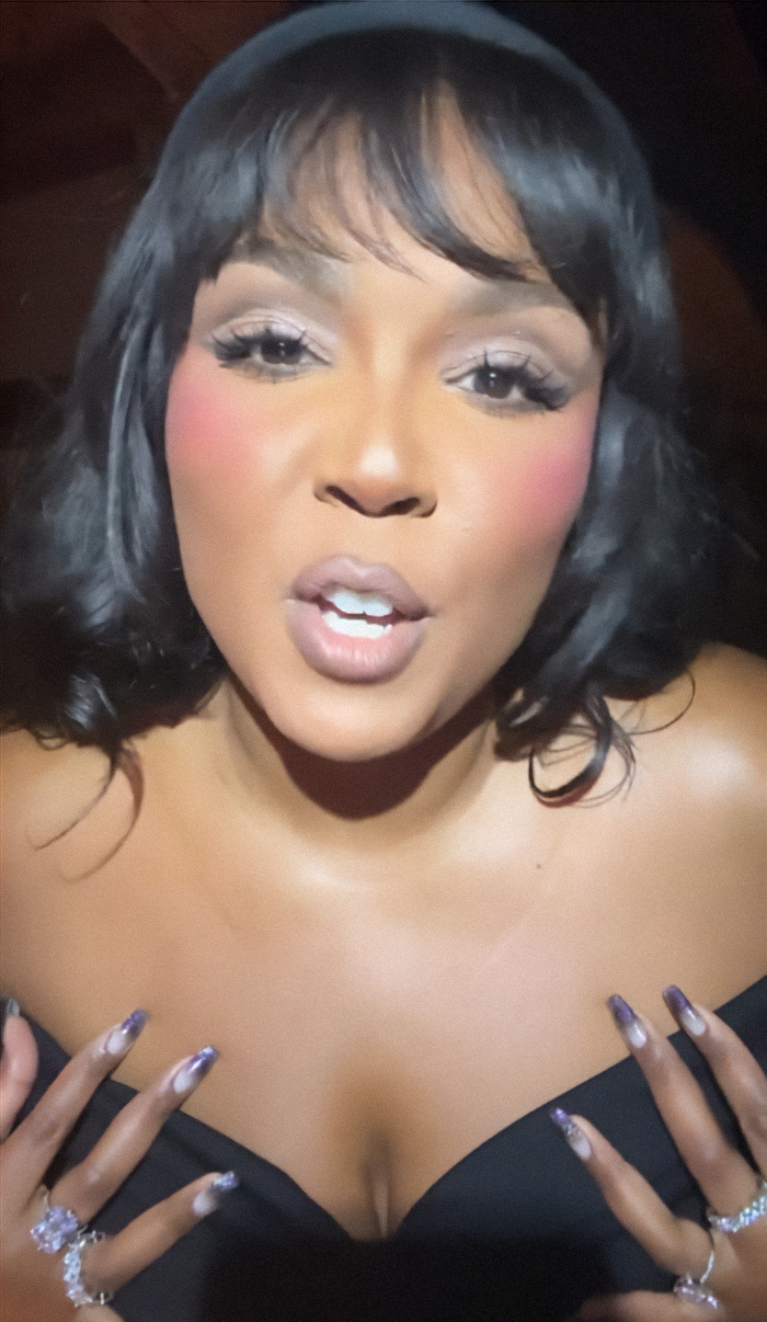 Lizzo with styled hair and makeup looks confidently into the camera, showcasing her weight loss in a black outfit. Lizzo with styled hair and makeup looks confidently into the camera, showcasing her weight loss in a black outfit.