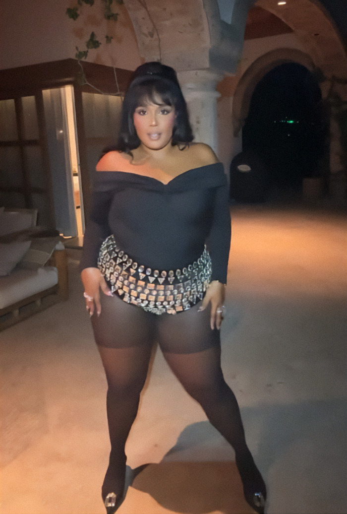 Lizzo in a stylish black outfit celebrates weight loss journey, posing confidently indoors. Lizzo in a stylish black outfit celebrates weight loss journey, posing confidently indoors.