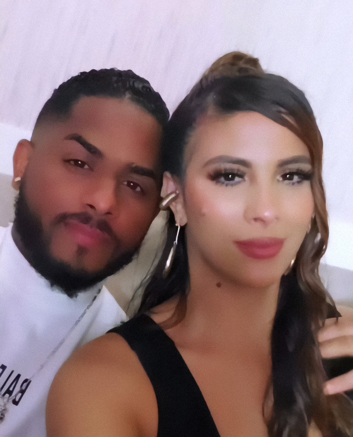 Influencer with her husband poses together.