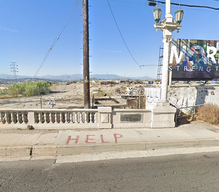 Mysterious "Help" sign on sidewalk in urban area, viewed on Google Earth.