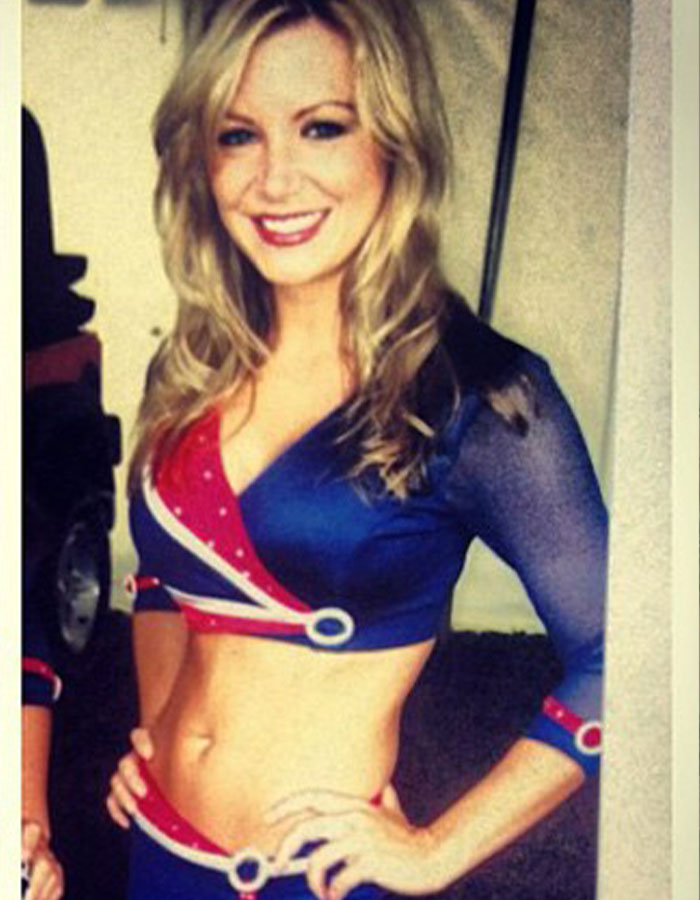 Former Buffalo Bills cheerleader in uniform, smiling, with hands on hips. Former Buffalo Bills cheerleader in uniform, smiling, with hands on hips.