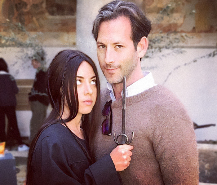 Aubrey Plaza holding a sword next to Jeff Baena outdoors. Aubrey Plaza holding a sword next to Jeff Baena outdoors.