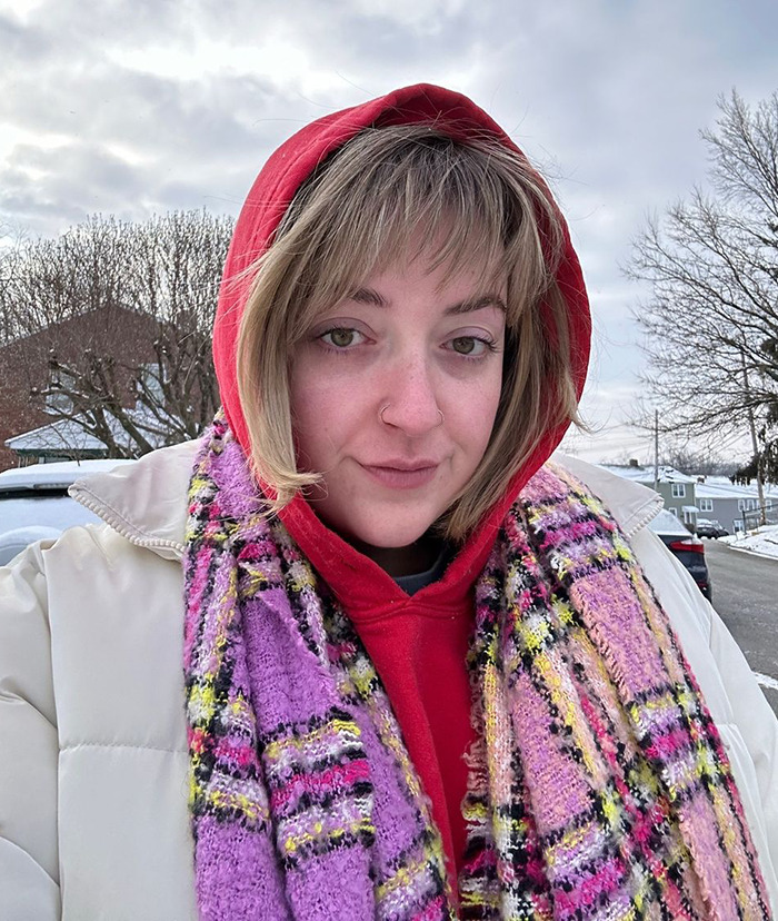 Madison Vaughan wearing a scarf and a hoodie takes a selfie outdoors, Madison Vaughan wearing a scarf and a hoodie takes a selfie outdoors,