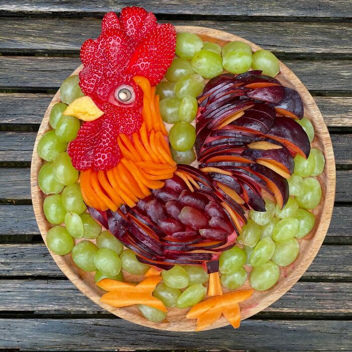 A rooster crafted from fruits and vegetables, showcasing healthy eating as art.