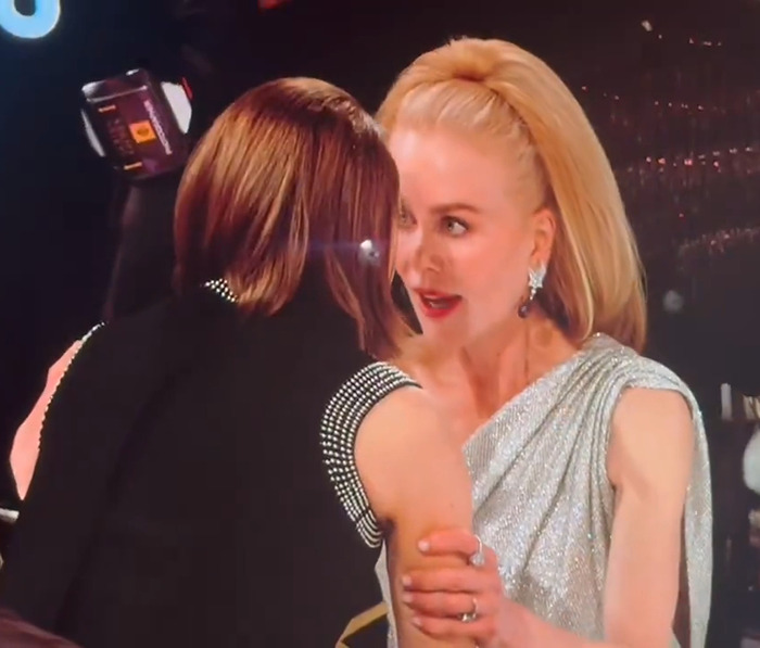 Nicole Kidman converses intently with Jodie Foster at a formal event.