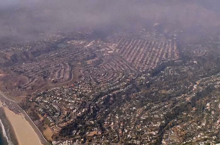 Aerial view of Los Angeles neighborhoods affected by wildfires amidst water limit controversies. Aerial view of Los Angeles neighborhoods affected by wildfires amidst water limit controversies.