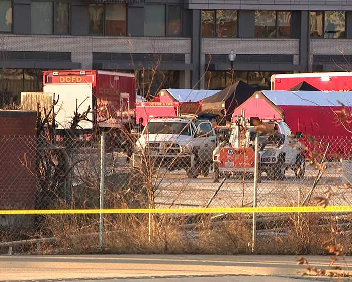 Emergency vehicles and tents at the scene of a DC American Airlines plane crash.