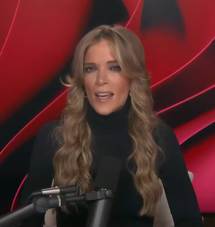 Megyn Kelly speaking into a microphone, wearing a black top, against a red background; discussing female firefighter leaders.