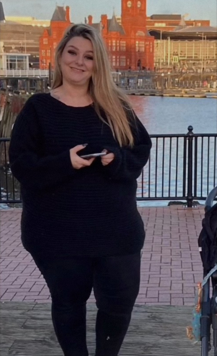 Kelly Wynne standing outdoors with a stroller. Kelly Wynne standing outdoors with a stroller.