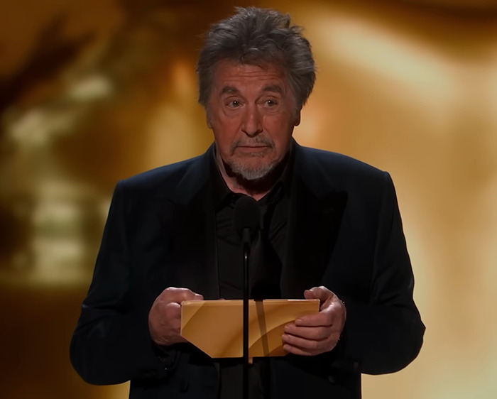 Al Pacino holding an envelope on stage during an awkward awards show moment in 2024.