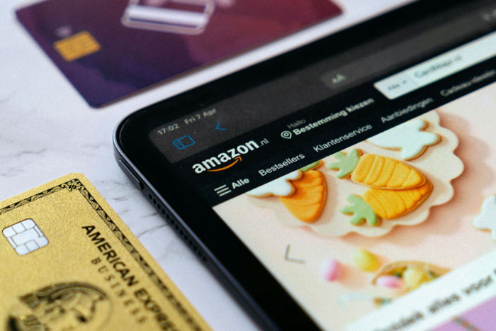 Amazon app open on a smartphone, with credit cards nearby, symbolizing AI-driven shopping changes. Amazon app open on a smartphone, with credit cards nearby, symbolizing AI-driven shopping changes.